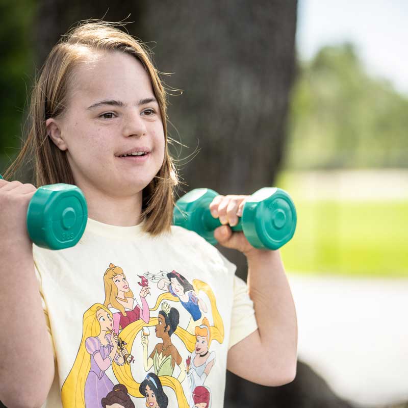 AFI client holding dumbbells