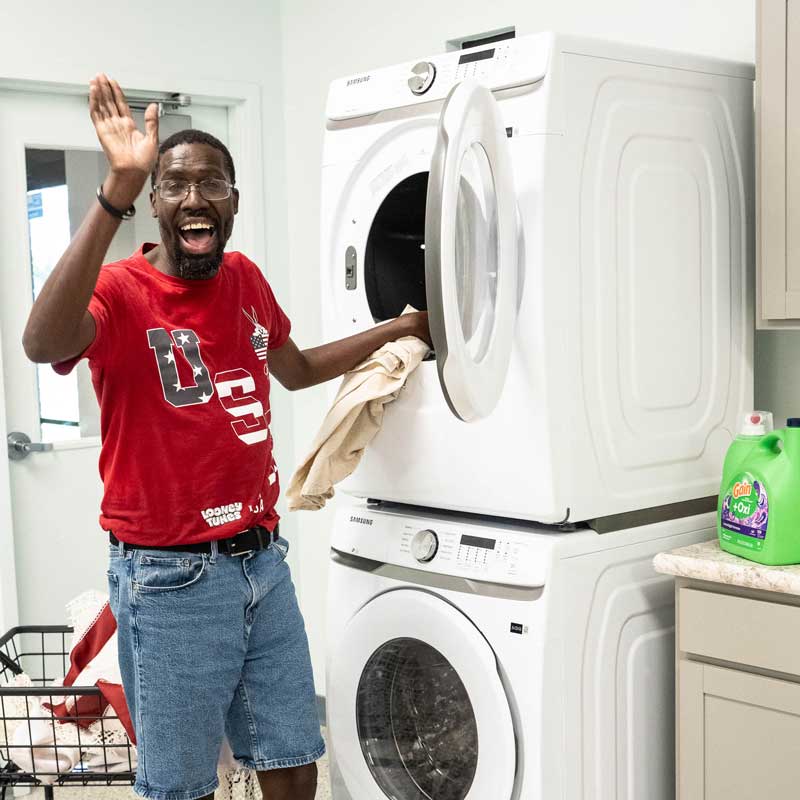 AFI client doing laundry