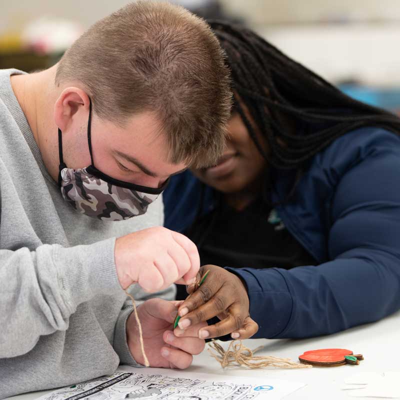 AFI instructor and client doing crafts